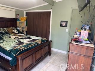 720 Le Borgne Ave, La Puente, CA 91746 - bedroom featuring lofted ceiling, baseboards, and light tile patterned floors