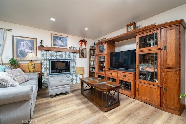 7191 Nixon Dr, Riverside, CA 92504 - living room featuring light wood finished floors, a tile fireplace, and recessed lighting