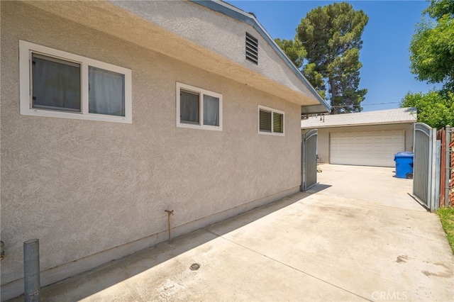 7191 Nixon Dr, Riverside, CA 92504 - view of home's exterior featuring stucco siding, an outbuilding, and a garage