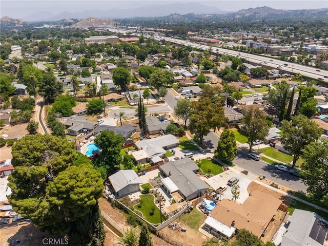 7191 Nixon Dr, Riverside, CA 92504 - aerial view of property's location featuring a mountain backdrop and nearby suburban area