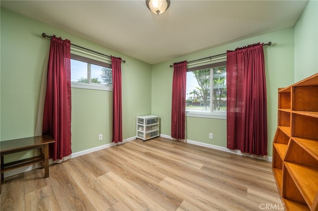 7191 Nixon Dr, Riverside, CA 92504 - empty room with wood finished floors, healthy amount of natural light, and baseboards