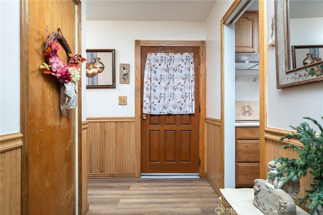 7191 Nixon Dr, Riverside, CA 92504 - entryway featuring a wainscoted wall, light wood-style flooring, and wood walls