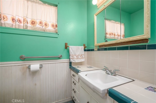 7191 Nixon Dr, Riverside, CA 92504 - bathroom featuring vanity, a wainscoted wall, and decorative backsplash