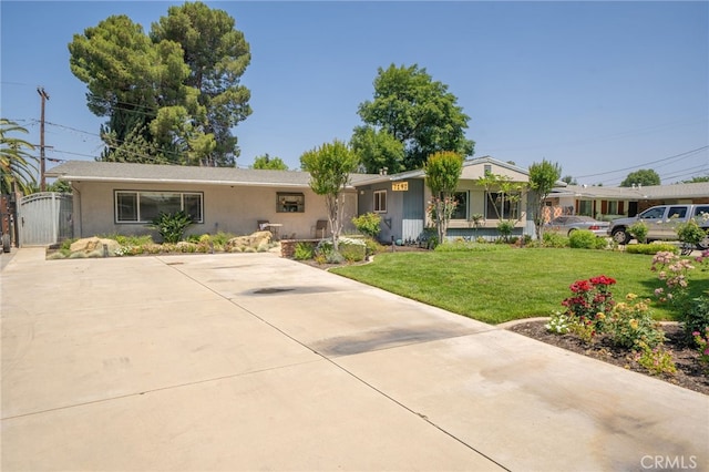 7191 Nixon Dr, Riverside, CA 92504 - ranch-style house with a front yard, stucco siding, and a gate