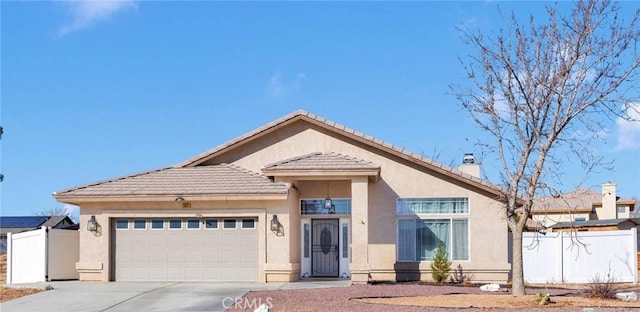 26822 Corona Dr, Helendale, CA 92342 - ranch-style home with an attached garage, stucco siding, a chimney, driveway, and a tile roof