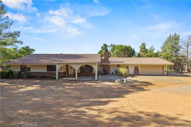 31681 Indian Oak Rd, Acton, CA 93510 - single story home featuring a tiled roof, a chimney, driveway, an attached garage, and stucco siding