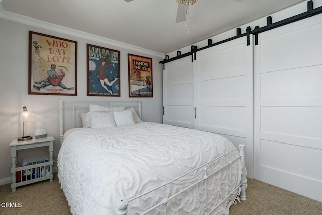 12983 Camden Ct, Moorpark, CA 93021 - carpeted bedroom with crown molding, a barn door, baseboards, and a ceiling fan