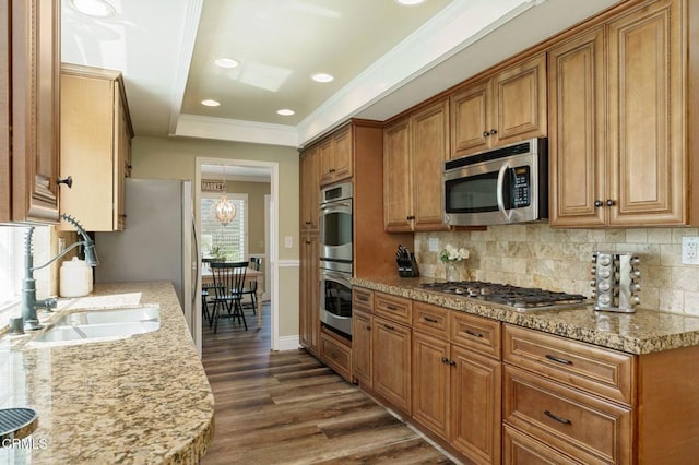 12983 Camden Ct, Moorpark, CA 93021 - kitchen featuring stainless steel appliances, backsplash, brown cabinets, dark wood-type flooring, and a sink