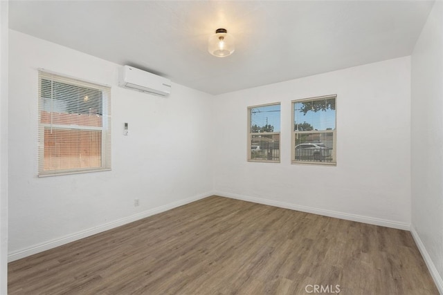 217 N Mcclay St, Santa Ana, CA 92701 - unfurnished room featuring a wall unit AC, wood finished floors, and baseboards