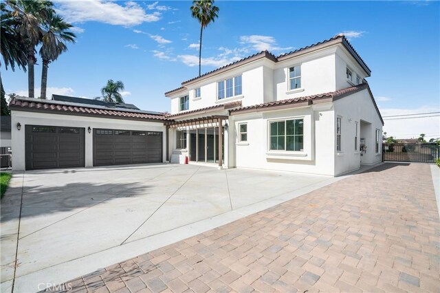 5305 Glickman Ave, Temple City, CA 91780 - mediterranean / spanish-style house featuring concrete driveway, stucco siding, solar panels, a tile roof, and a garage