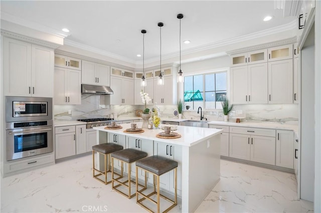 5305 Glickman Ave, Temple City, CA 91780 - kitchen featuring stainless steel appliances, a sink, under cabinet range hood, light marble finish floors, and a kitchen breakfast bar