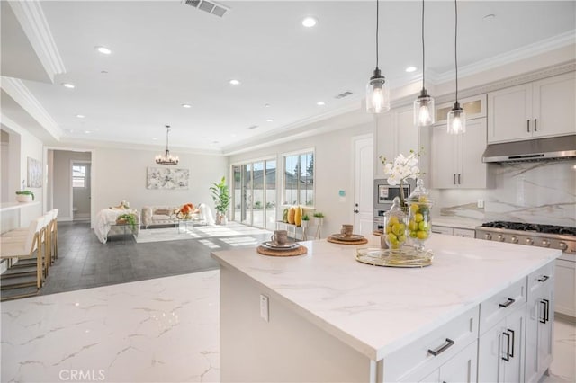 5305 Glickman Ave, Temple City, CA 91780 - kitchen featuring under cabinet range hood, light stone counters, recessed lighting, crown molding, and a kitchen island