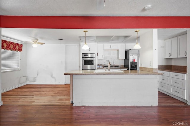 5331 Vallecito Ave, Westminster, CA 92683 - kitchen featuring stainless steel appliances, dark wood finished floors, a ceiling fan, and hanging light fixtures