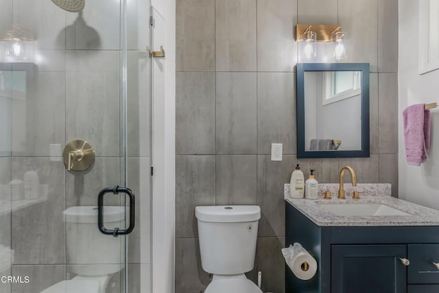 7745 Geyser Ave, Reseda, CA 91335 - bathroom featuring tile walls, a shower stall, vanity, and toilet