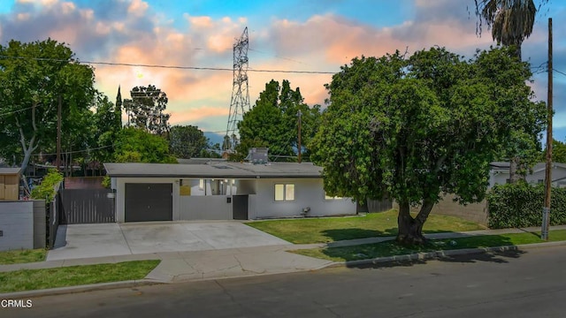 7745 Geyser Ave, Reseda, CA 91335 - view of front of property with a garage, concrete driveway, a front lawn, and stucco siding