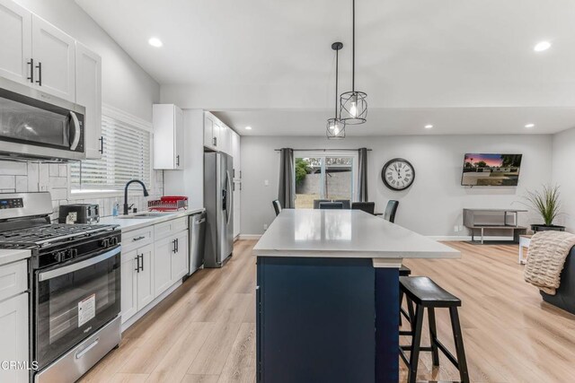 7745 Geyser Ave, Reseda, CA 91335 - kitchen featuring stainless steel appliances, a sink, a breakfast bar area, a center island, and recessed lighting