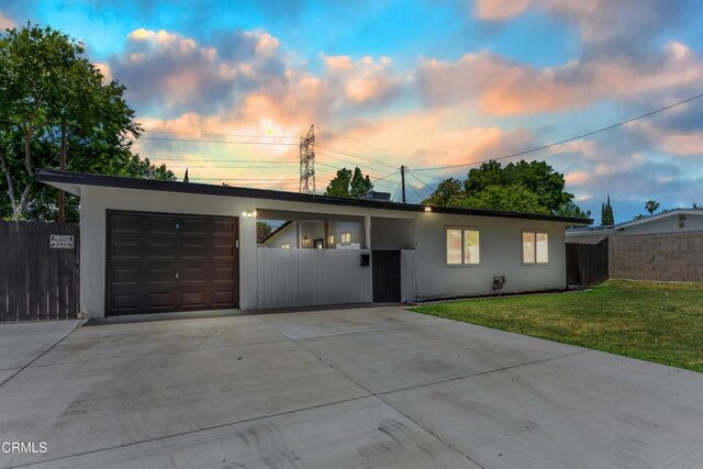 7745 Geyser Ave, Reseda, CA 91335 - view of front of home featuring driveway, an attached garage, and stucco siding