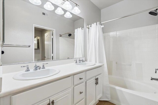 3023 Pacific Palm Way, San Diego, CA 92117 - bathroom featuring shower / bath combo with shower curtain and double vanity