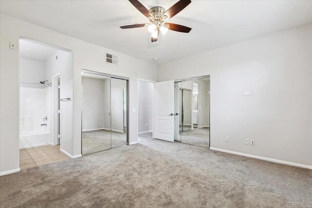 3023 Pacific Palm Way, San Diego, CA 92117 - unfurnished bedroom featuring carpet flooring, two closets, ensuite bath, and ceiling fan
