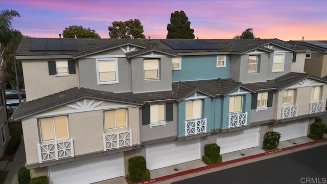 3023 Pacific Palm Way, San Diego, CA 92117 - view of front facade featuring an attached garage, stucco siding, solar panels, and a tile roof