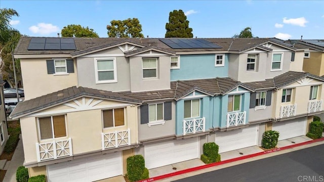 3023 Pacific Palm Way, San Diego, CA 92117 - view of property featuring a garage, roof mounted solar panels, stucco siding, and driveway