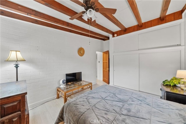 2324 Manchester Ave, Cardiff By The Sea, CA 92007 - bedroom featuring wood finished floors, beamed ceiling, a closet, and brick wall
