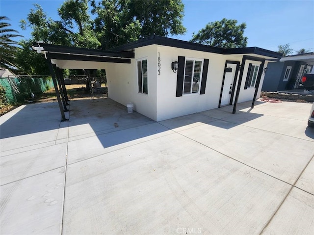18623 11th St, Bloomington, CA 92316 - view of front of house featuring stucco siding, a carport, and concrete driveway
