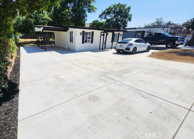 18623 11th St, Bloomington, CA 92316 - ranch-style home featuring concrete driveway, a carport, and stucco siding