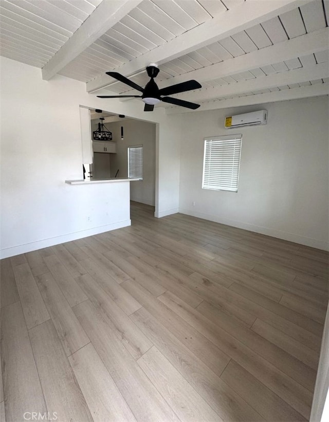 18623 11th St, Bloomington, CA 92316 - empty room featuring a wall mounted air conditioner, light wood-style floors, a ceiling fan, baseboards, and wood ceiling with exposed beams
