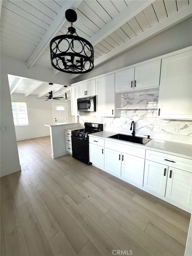 18623 11th St, Bloomington, CA 92316 - kitchen featuring gas stove, a sink, stainless steel microwave, white cabinets, and decorative backsplash