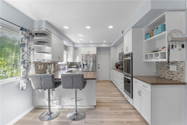 17426 Flanders St, Granada Hills, CA 91344 - kitchen with open shelves, appliances with stainless steel finishes, a peninsula, healthy amount of natural light, and recessed lighting