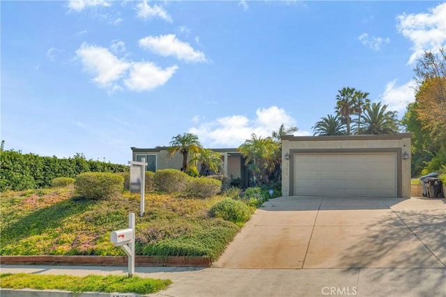 17426 Flanders St, Granada Hills, CA 91344 - view of front of property with driveway, an attached garage, and stucco siding