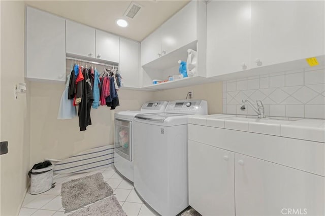 17426 Flanders St, Granada Hills, CA 91344 - laundry room with washing machine and clothes dryer, cabinet space, and light tile patterned floors