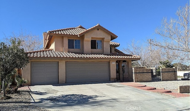 37713 57th St E, Palmdale, CA 93552 - view of front of property featuring driveway, stucco siding, a tiled roof, a garage, and a gate