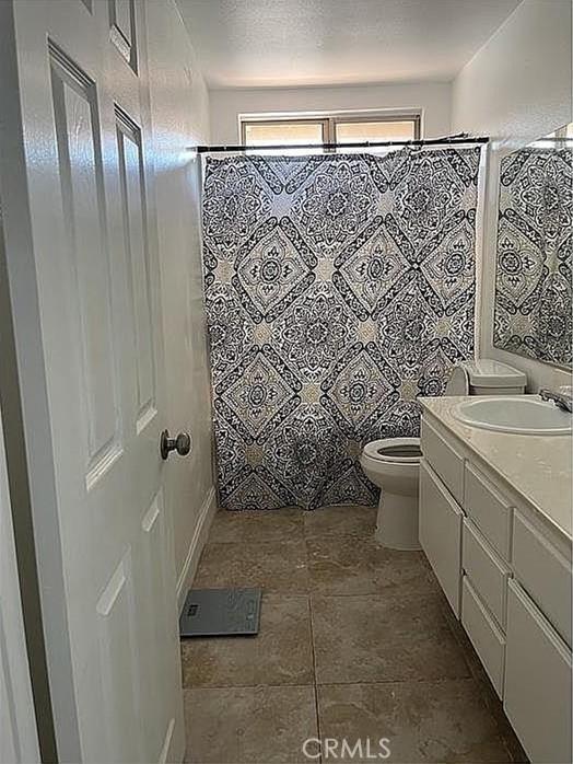 37713 57th St E, Palmdale, CA 93552 - bathroom featuring toilet, vanity, and a shower with shower curtain