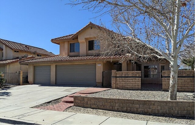 37713 57th St E, Palmdale, CA 93552 - view of front of home featuring stucco siding, a fenced front yard, driveway, a tiled roof, and a gate
