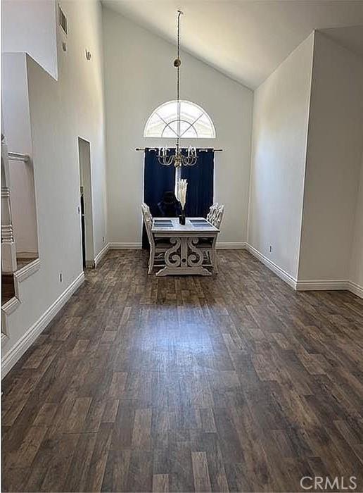 37713 57th St E, Palmdale, CA 93552 - dining area featuring wood finished floors, a chandelier, baseboards, and high vaulted ceiling