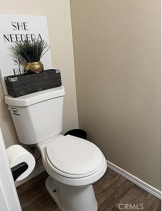37713 57th St E, Palmdale, CA 93552 - bathroom featuring toilet, wood finished floors, and baseboards