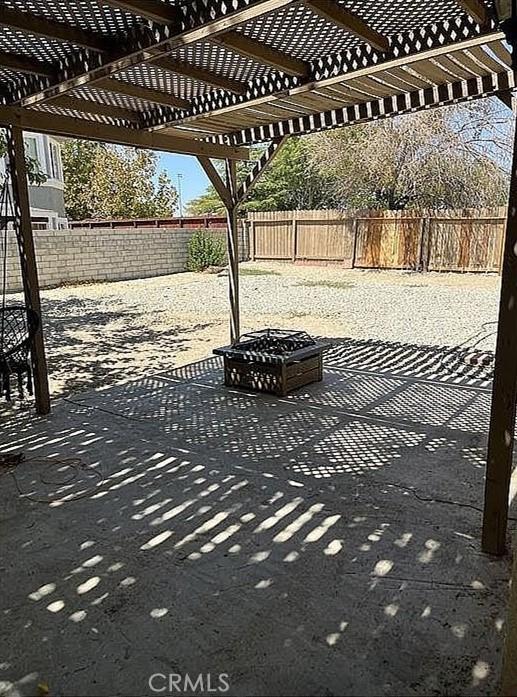 37713 57th St E, Palmdale, CA 93552 - fenced backyard featuring a fire pit, a pergola, and a patio area