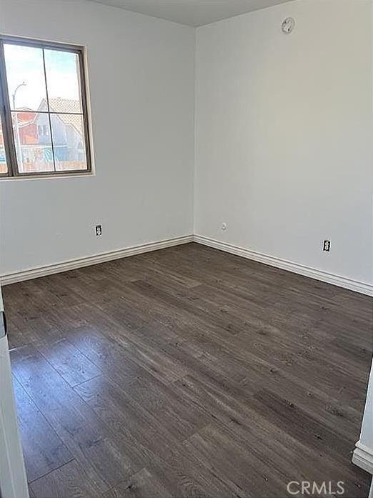 37713 57th St E, Palmdale, CA 93552 - empty room featuring dark wood-type flooring and baseboards