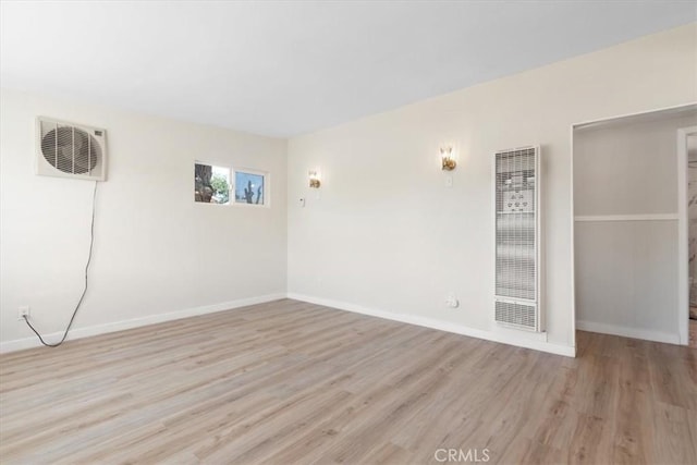 12074 Lee Ave, Adelanto, CA 92301 - unfurnished room with a heating unit, wood finished floors, and baseboards