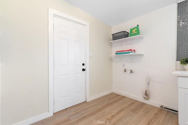 12074 Lee Ave, Adelanto, CA 92301 - washroom with light wood-style floors and baseboards