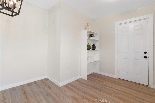 12074 Lee Ave, Adelanto, CA 92301 - interior space featuring a chandelier, light wood-style flooring, and baseboards