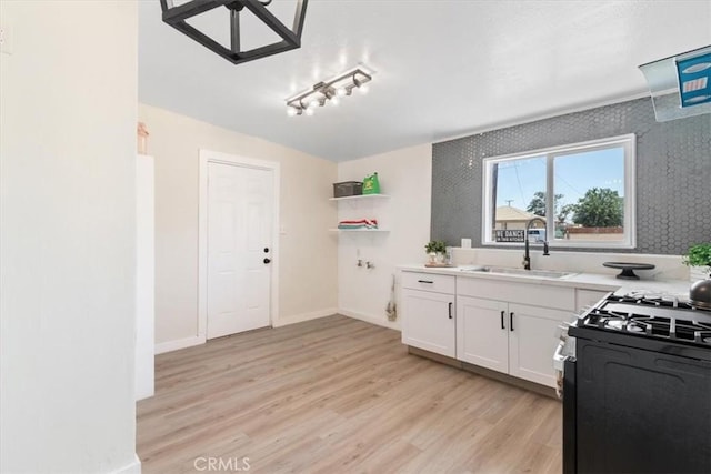 12074 Lee Ave, Adelanto, CA 92301 - kitchen featuring range with gas cooktop, a sink, white cabinets, open shelves, and light countertops