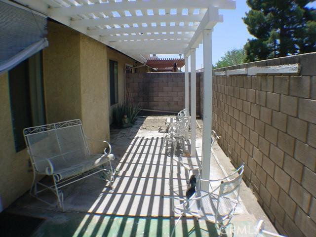 1412 Colonial Way, San Jacinto, CA 92583 - fenced backyard featuring a pergola and a patio