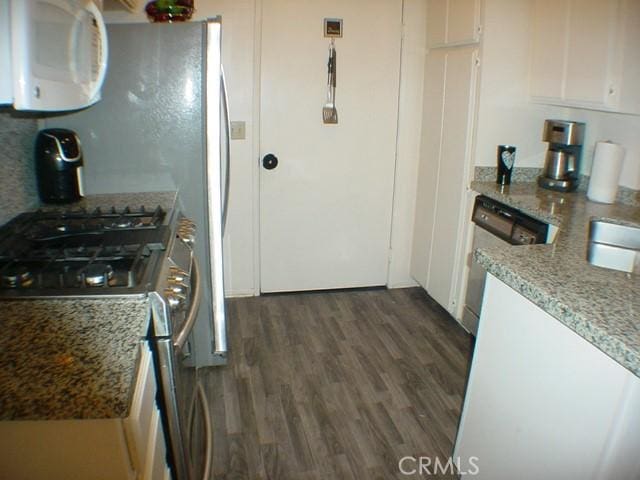 1412 Colonial Way, San Jacinto, CA 92583 - kitchen with stainless steel appliances, dark wood-style flooring, white cabinetry, and light stone countertops