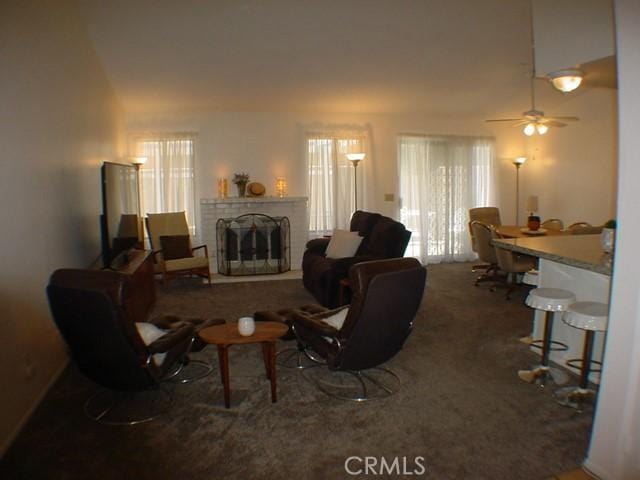 1412 Colonial Way, San Jacinto, CA 92583 - living area featuring healthy amount of natural light, carpet floors, a brick fireplace, and a ceiling fan