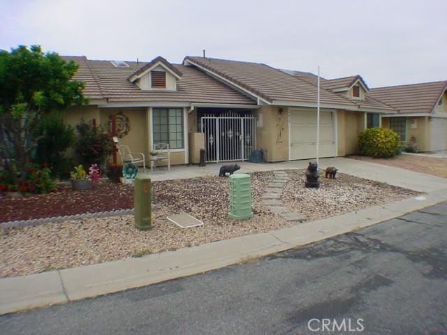1412 Colonial Way, San Jacinto, CA 92583 - single story home with an attached garage, stucco siding, concrete driveway, and a tiled roof