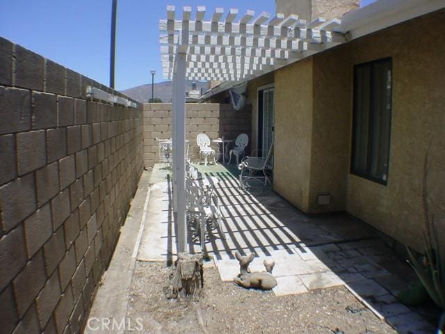 1412 Colonial Way, San Jacinto, CA 92583 - fenced backyard featuring a patio area and a pergola