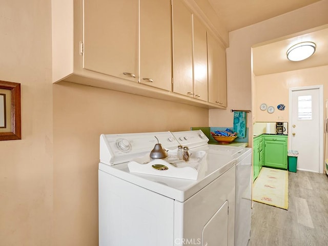 639 Magnolia Ave, Inglewood, CA 90301 - laundry area featuring washer and clothes dryer, cabinet space, and light wood-style flooring
